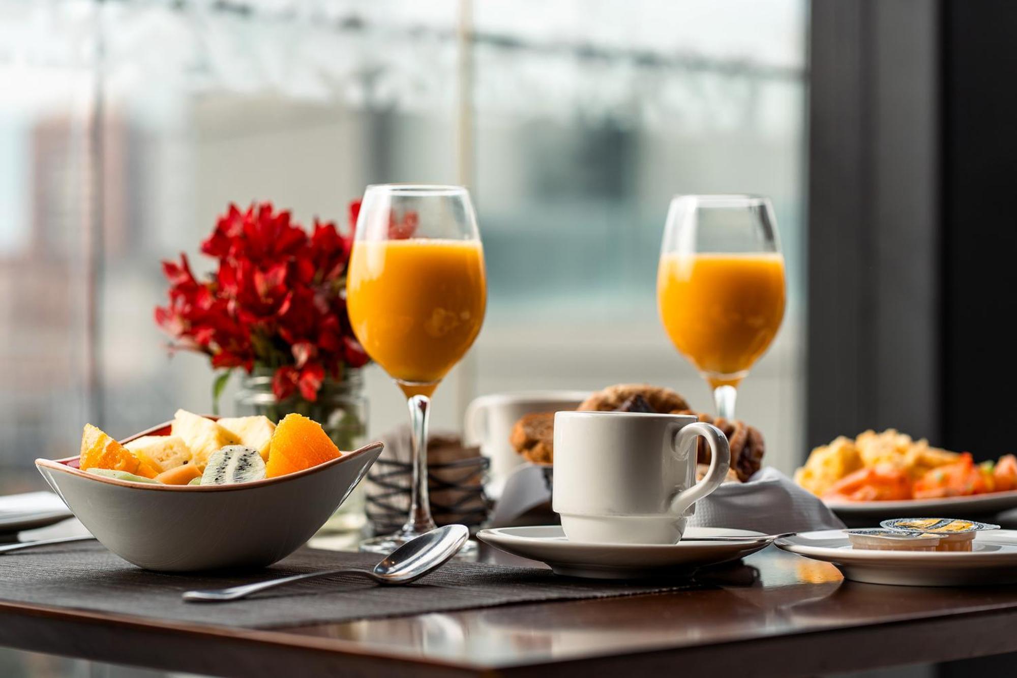 Hotel Cumbres Lastarria Santiago Exterior photo A breakfast with fruit, orange juice, and coffee